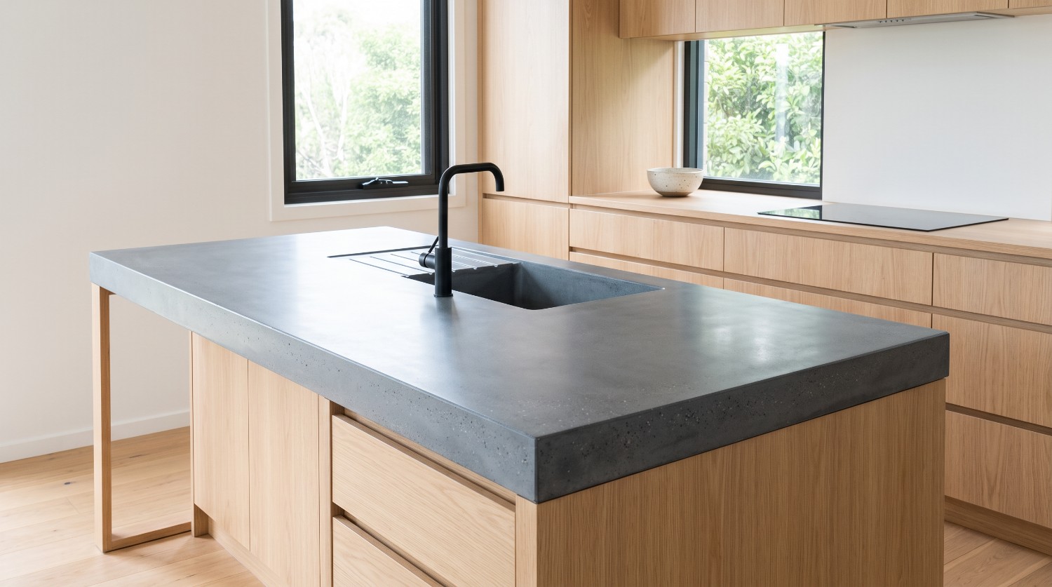 Honed pewter island with the sink and drainer cast as part of the top, a custom concrete benchtop in Launceston