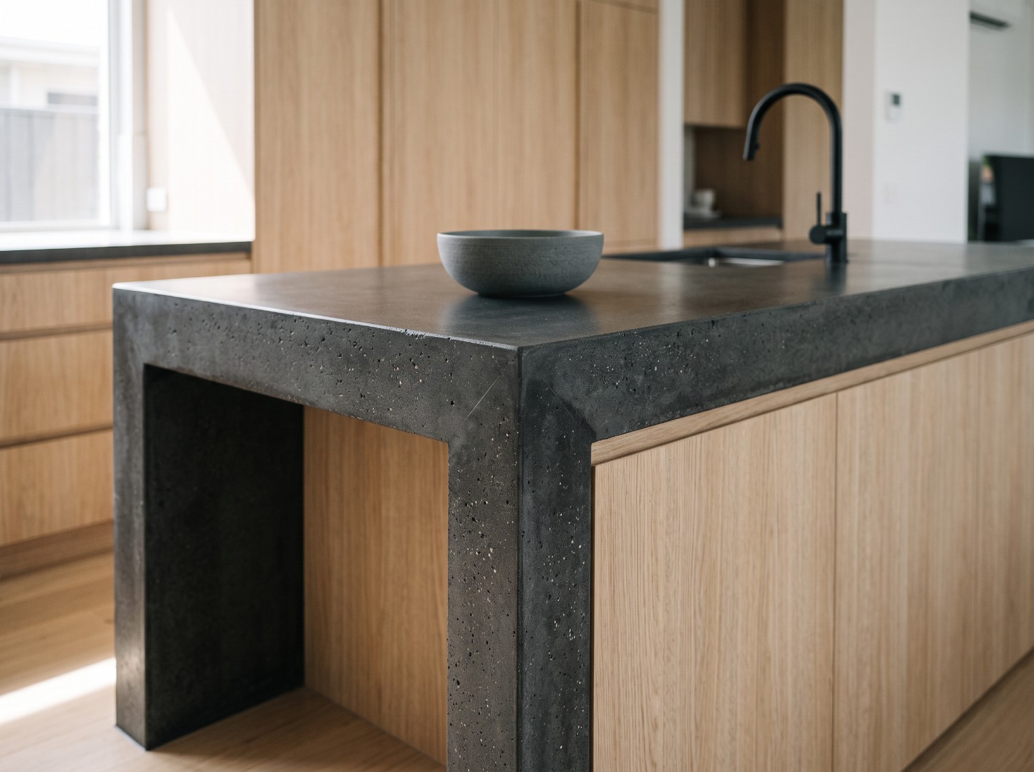 Charcoal, 100mm chunky edge, returned down the end as a waterfall, a custom concrete benchtop in Launceston
