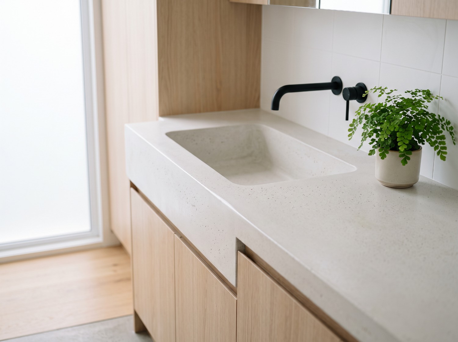 Chalk white laundry top with a deep trough moulded into it, a custom concrete benchtop in Launceston