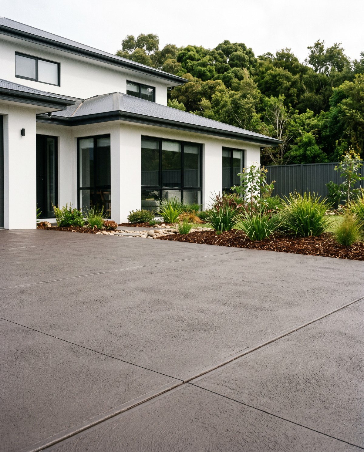 A charcoal coloured concrete driveway at a Launceston home