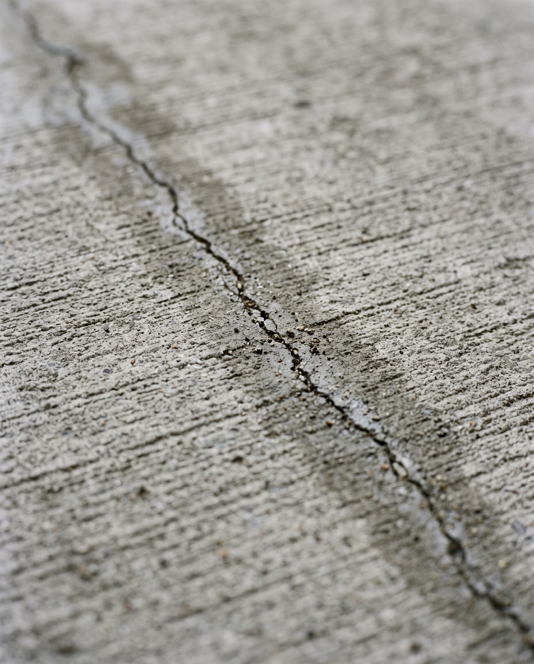 A fine hairline crack in the surface of a concrete slab in Launceston
