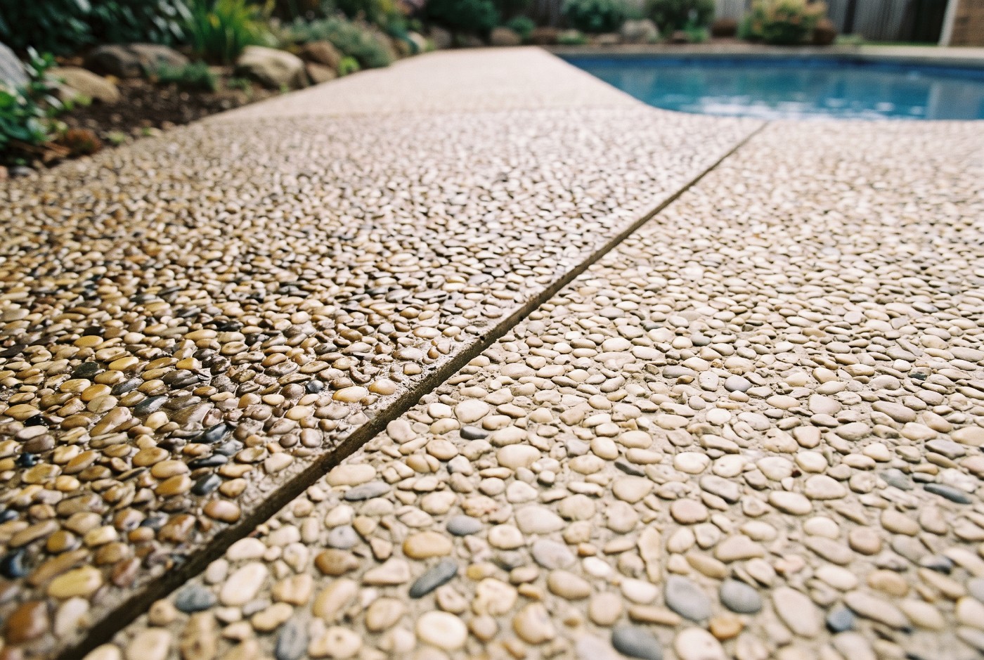 A pool surround half sealed and half unsealed, showing the difference in colour and sheen